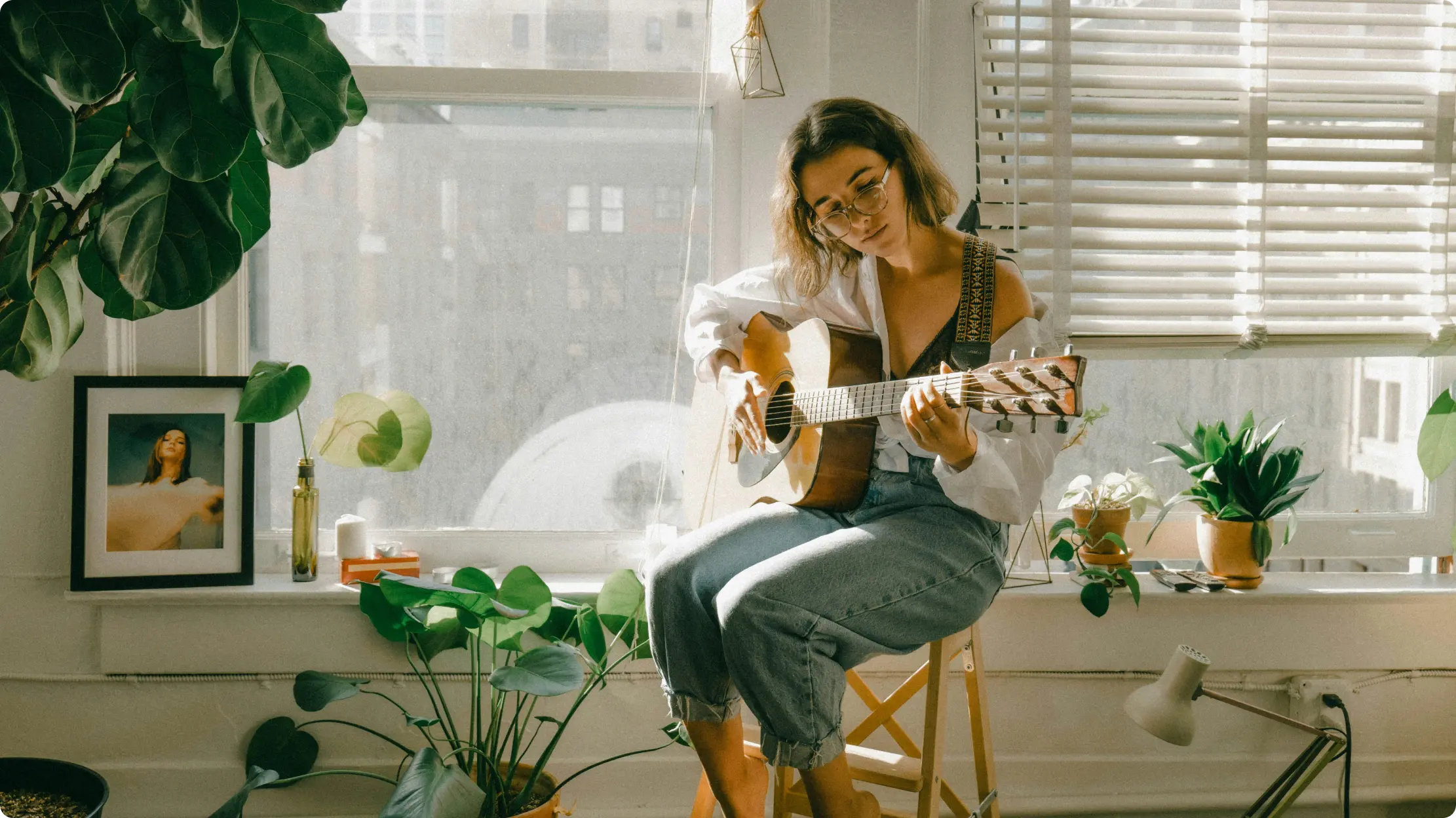 Girl playing guitar in the sunlight.