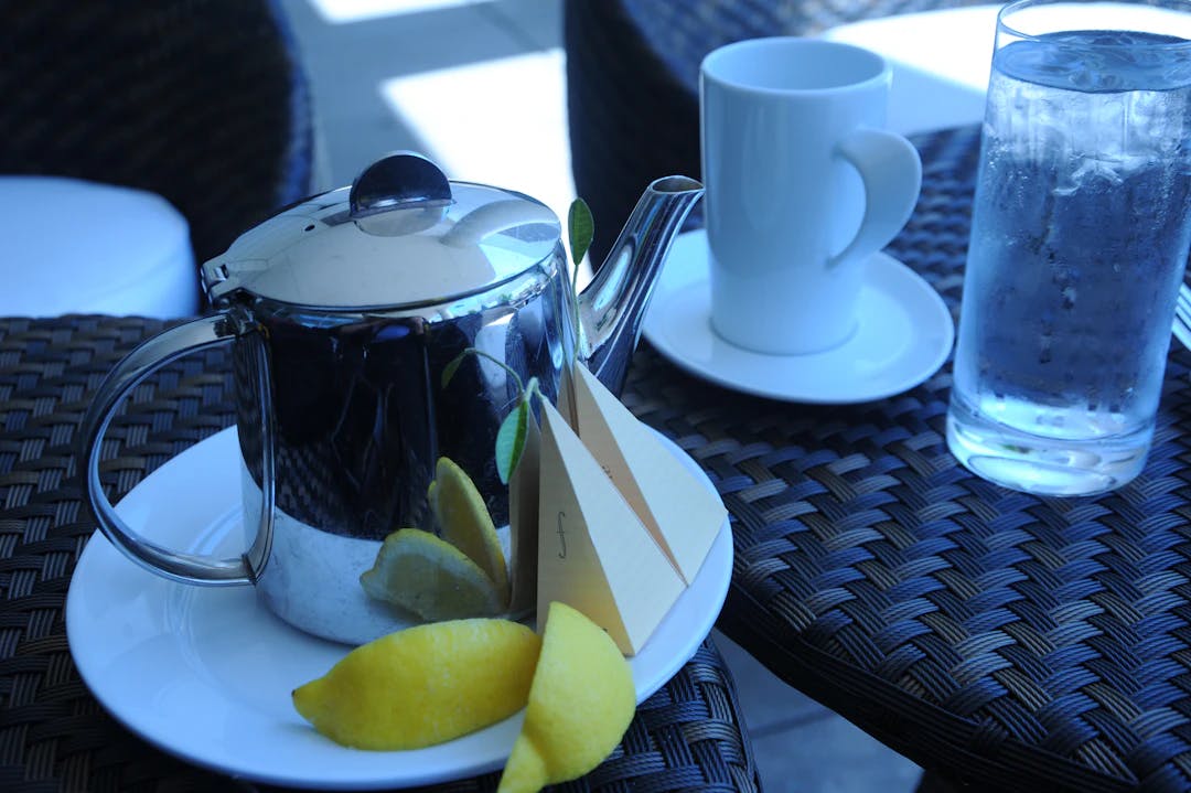 silver teapot and white ceramic mug