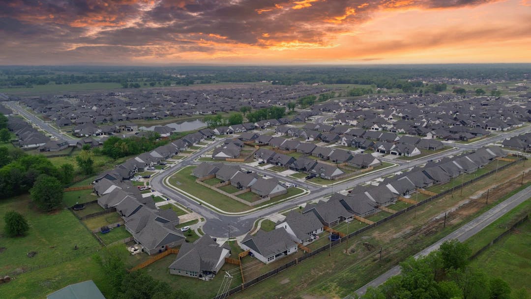an aerial view of a neighborhood at sunset